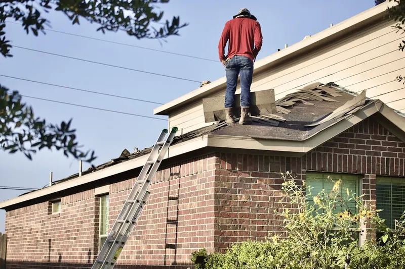 Professional roofer working on a residential roof in Ottsville